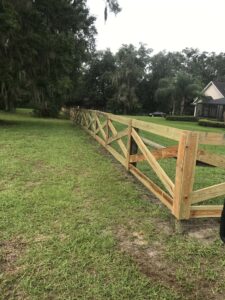 Wood board ranch fence corner section installed on rural Florida property