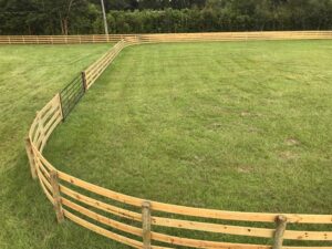 Straight ranch rail farm fence across open pasture in Marion County Florida