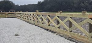 Decorative cross-board ranch fence installed on rural property in Florida