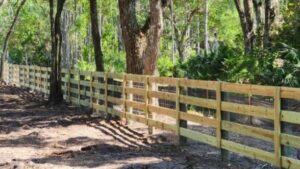 Ranch rail farm fence installed on wooded property by Southern Pro Fence & Gate in Florida
